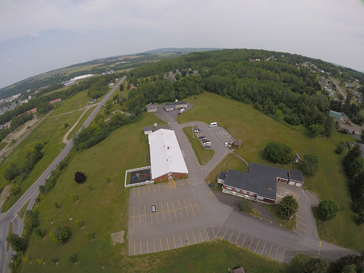An aerial view of three buildings 
